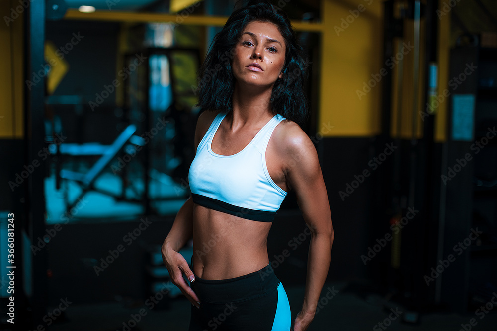 Fit sportswoman exercising and training at home