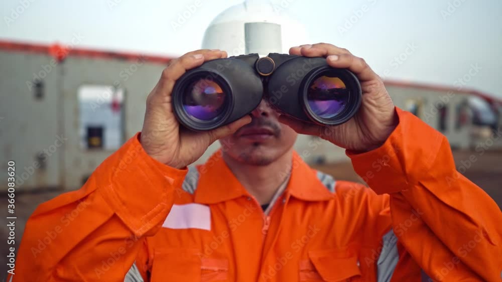 Filipino deck Officer on deck of vessel or ship , wearing PPE personal