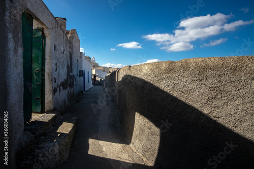 Courtyards of the white city of Santorini under the bright sun. Greece photo