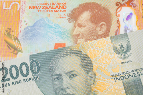 Wallpaper Mural A macro image of a grey two thousand Indonesian rupiah bank note paired up with a orange, plastic five dollar bill from New Zealand.  Shot close up in macro. Torontodigital.ca