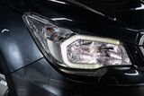 Black car headlights. Exterior detail. Close up detail on one of the LED headlights modern car..