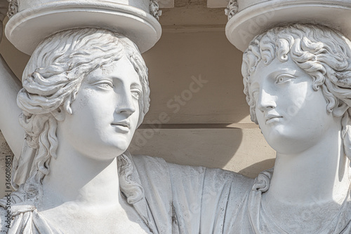 Photography Portrait of balcony support statues of artistic young and naked sensual Roman Renaissance Era women in historical downtown of Vienna, Austria, details, closeup