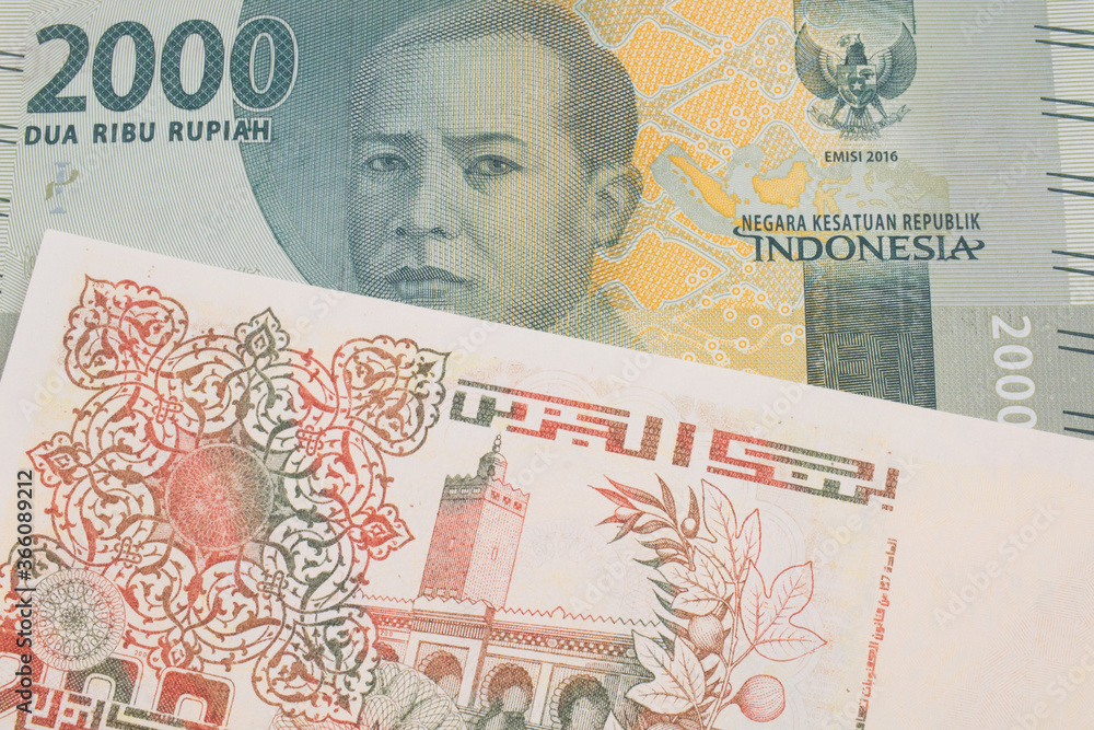 Fototapeta premium A macro image of a grey two thousand Indonesian rupiah bank note paired up with a beige 200 Algerian dinar bank note. Shot close up in macro.