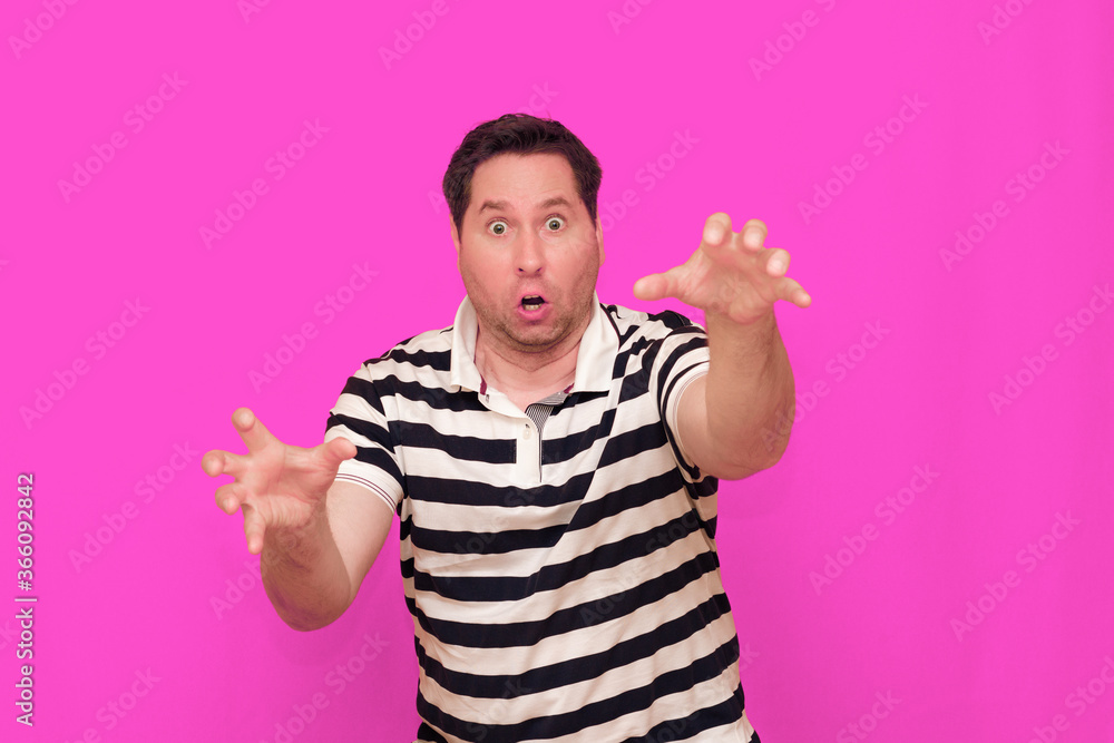 Naklejka premium Caucasian man wearing casual striped t-shirt standing over isolated hot pink background shows various gestures.
