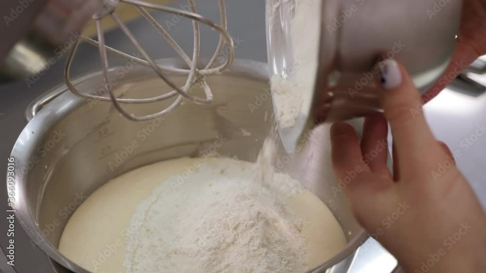 Flour pouring into bowl of food processor close-up. Food processor to kneading dough for bread. Manufacturing process of sweet cake. Flour pouring into bowl of food processor close-up. Food processor to kneading dough for bread. Manufacturing process of sweet cake.