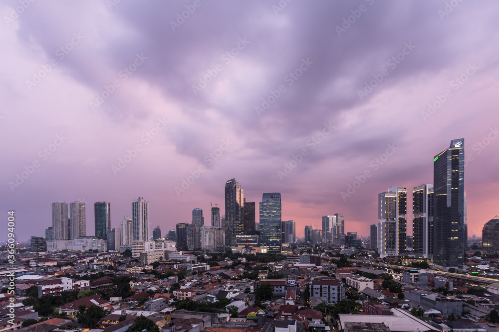 Aerial view of Jakarta business disrict skyline with a dramatic sky at sunset