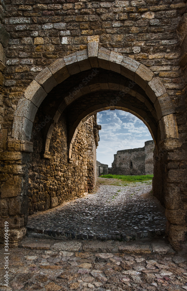Archway in the ancient stone wall