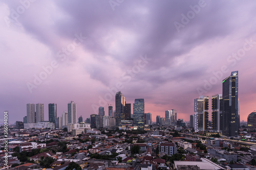Aerial view of Jakarta business disrict skyline with a dramatic sky at sunset photo
