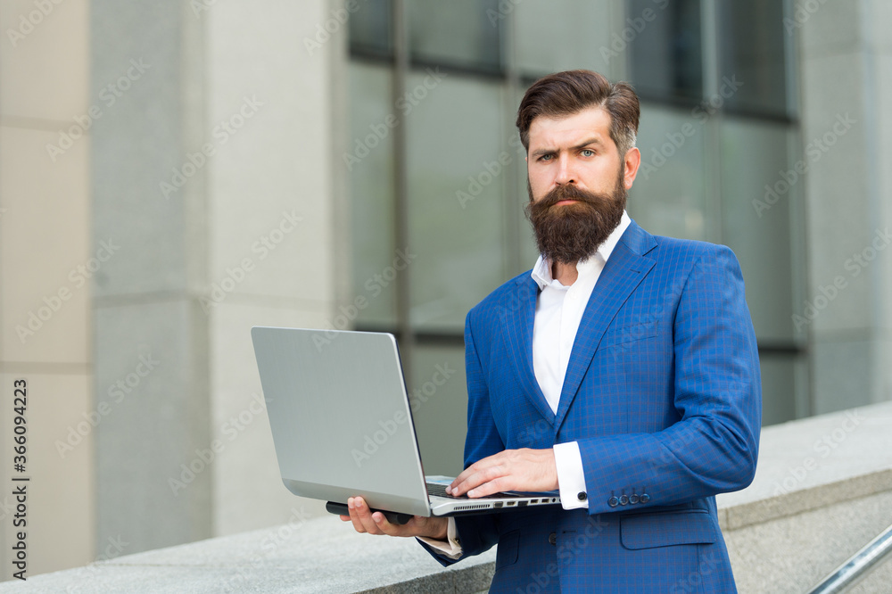 Be your own label. be always online. Confident male executive director with laptop. Successful man owner of company work on computer. handsome guy wear expensive office jacket. agile business Be your own label. be always online. Confident male executive director with laptop. Successful man owner of company work on computer. handsome guy wear expensive office jacket. agile business