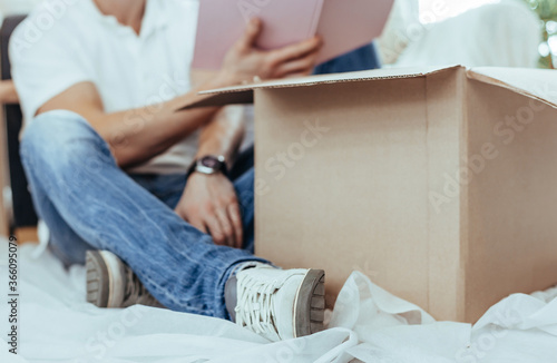 close up. young couple unpacking boxes in a new apartment.