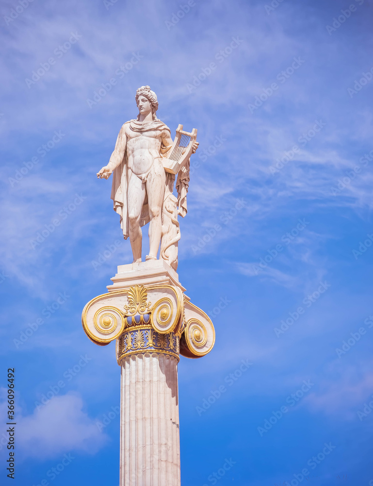 Apollo, the ancient Greek god of arts under impressive sky, Athens Greece Apollo, the ancient Greek god of arts under impressive sky, Athens Greece