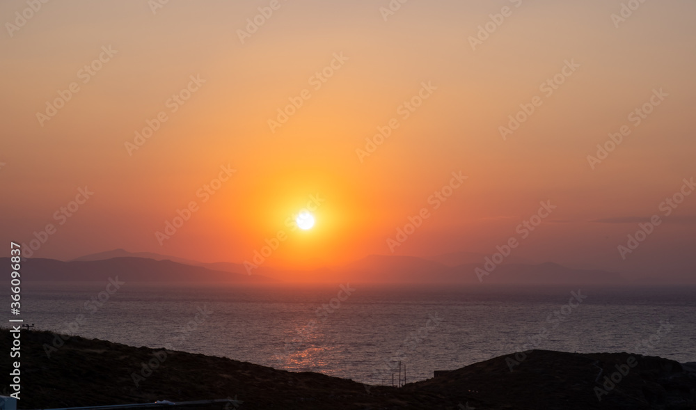 Obraz premium Sunrise, sunset. Twilight, dusk sky over sea water, mountain silhouette
