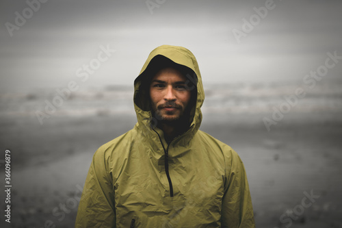 Portrait shot of adventurous looking male during bad weather photo