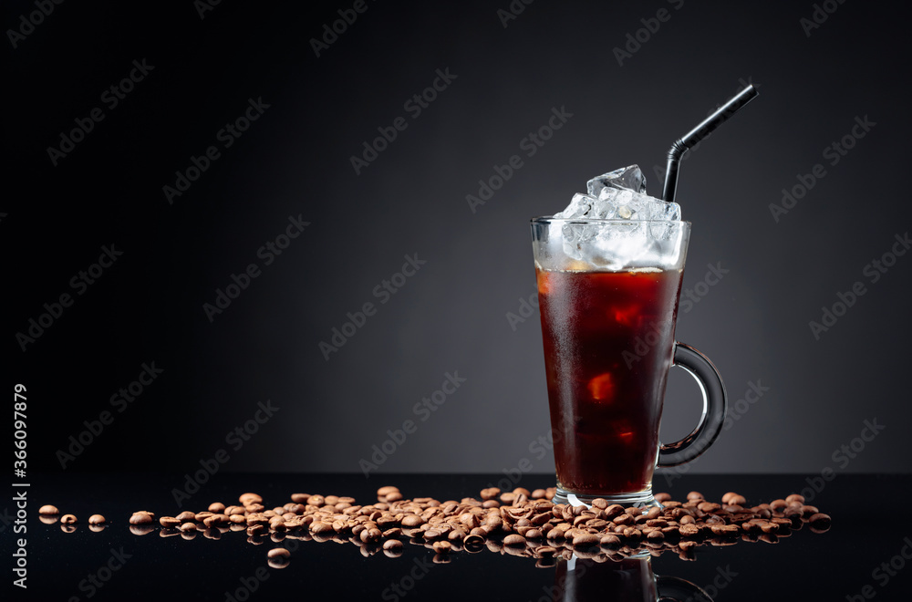 Ice coffee in frozen glass and coffee beans on a black reflective background. Ice coffee in frozen glass and coffee beans on a black reflective background.