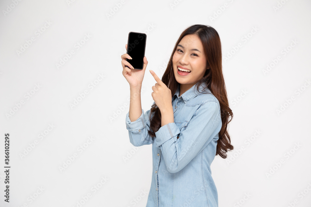 Portrait of Asian woman showing or presenting mobile phone application and pointing finger to smartphone on hand isolated over white background, Asian Thai model Portrait of Asian woman showing or presenting mobile phone application and pointing finger to smartphone on hand isolated over white background, Asian Thai model