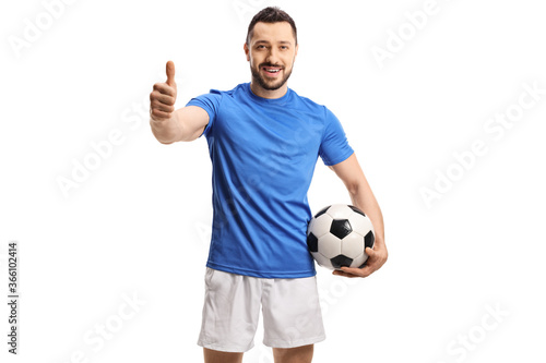 Soccer player holding a ball and giving a thumb up © Ljupco Smokovski
