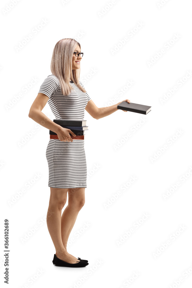 Full length profile shot of a blond woman giving a book Full length profile shot of a blond woman giving a book