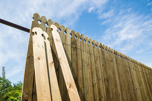 Installing a wooden fence. A few boards aren't attached yet.
