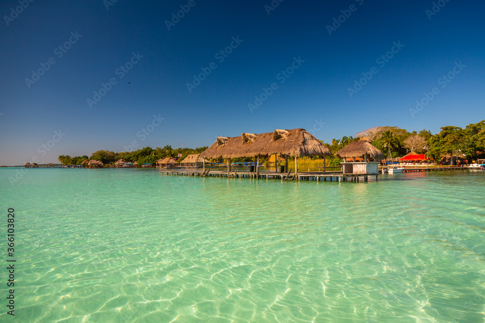 Laguna de Bacalar is also known as the Lagoon of Seven Colors, in Bacalar, Mexico. The crystal clear waters and white sandy bottom of the lake cause the water color to morph into different Colors.