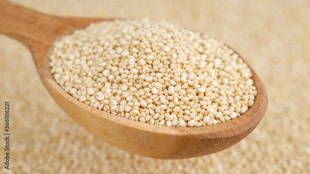 quinoa seeds in wooden spoon and on background. top view quinoa seeds in wooden spoon and on background. top view