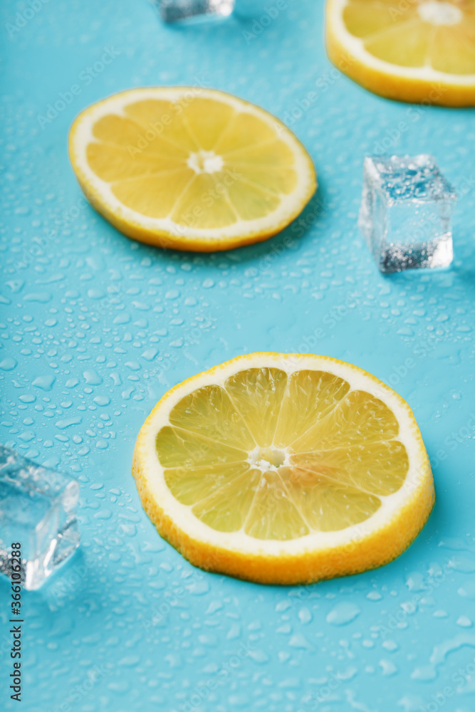Slices of fresh lemon on a blue background with ice. Slices of fresh lemon on a blue background with ice.
