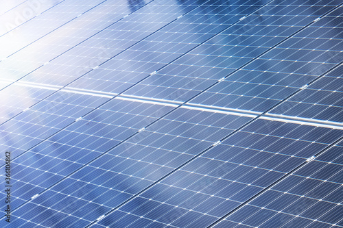 Solar panels with sun rays and cloud reflections