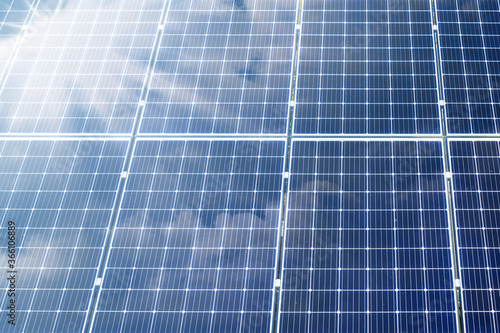 Solar panels with sun rays and cloud mirroring