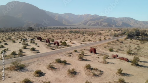 Aerial side view of a large serpent sculpture in the dry desert of Borrego Springs, California. photo