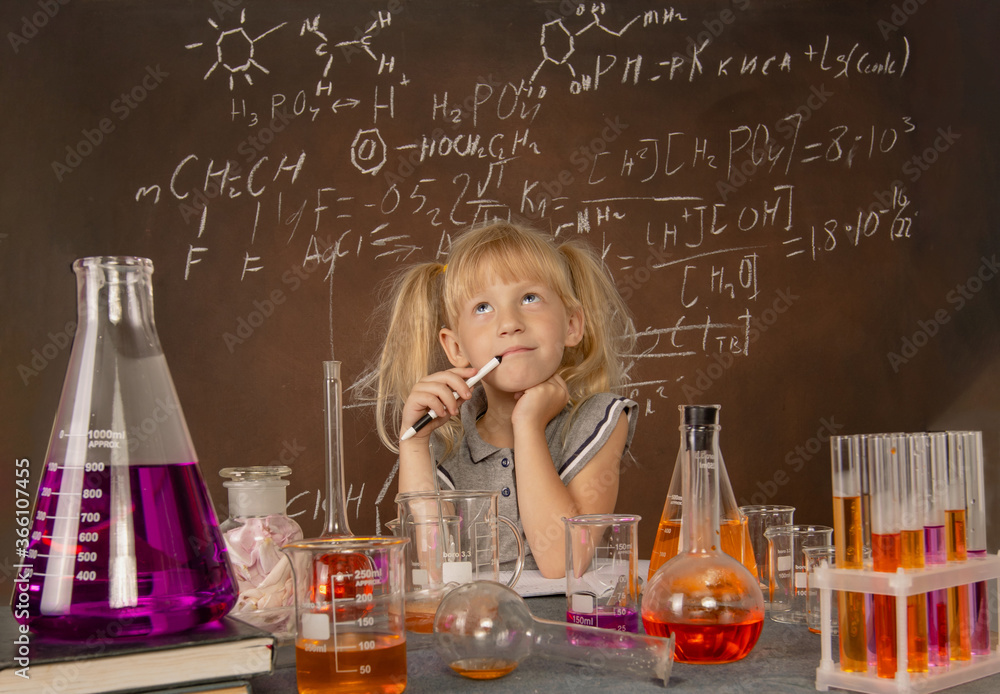Curious little girl with test tubes and colorful substances makes tests at school laboratory. Small kid learning chemistry and conducts science experiment on biology lesson. Biology education concept. Curious little girl with test tubes and colorful substances makes tests at school laboratory. Small kid learning chemistry and conducts science experiment on biology lesson. Biology education concept.