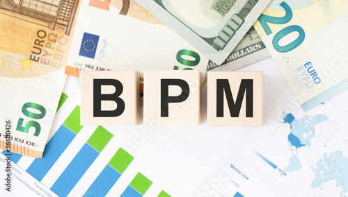 Acronym BPM - Business process management. Wooden small cubes with letters isolated on black background with copy space available. Business Concept image.