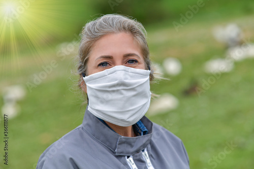 Portrait of a female farmer wearing a protective mask during the coronavirus crisis photo