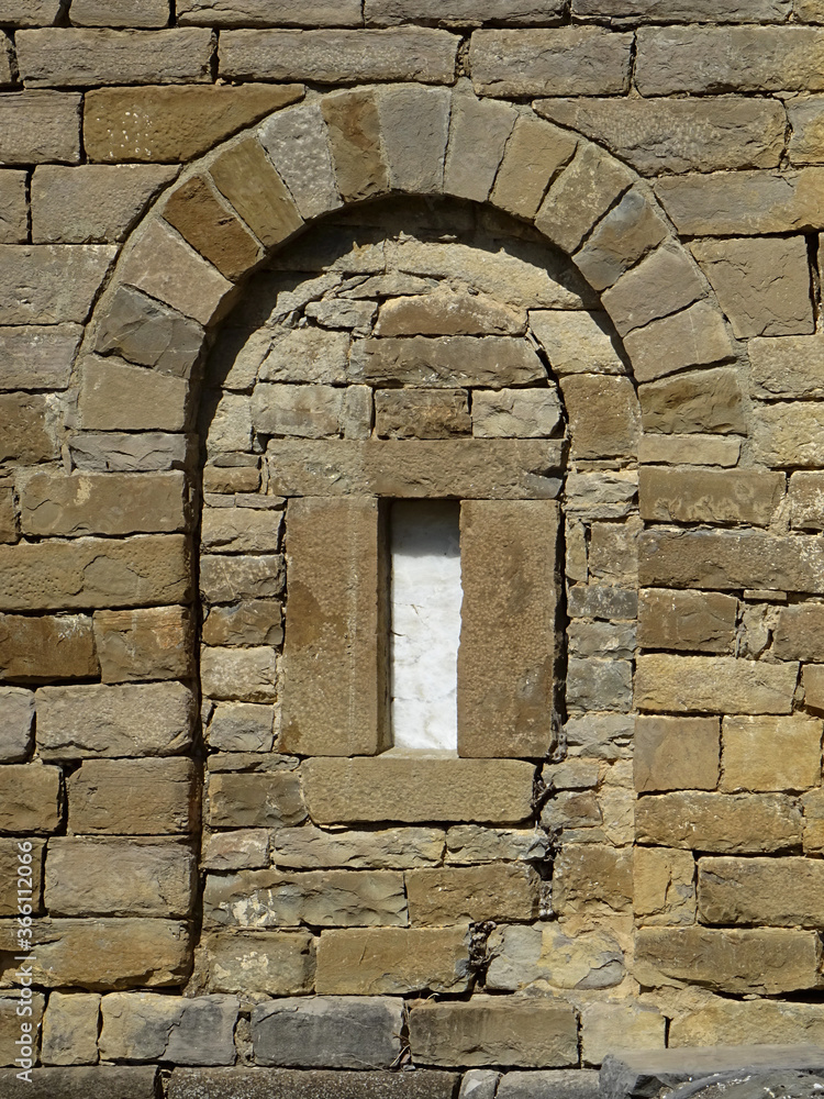 Detail of wall, arch and window in the Mozarab Pre-Romanesque or Romanesque Church of San Pedro de Larrede in the Serrablo Region. 10th-11th century. Aragon. Spain. 