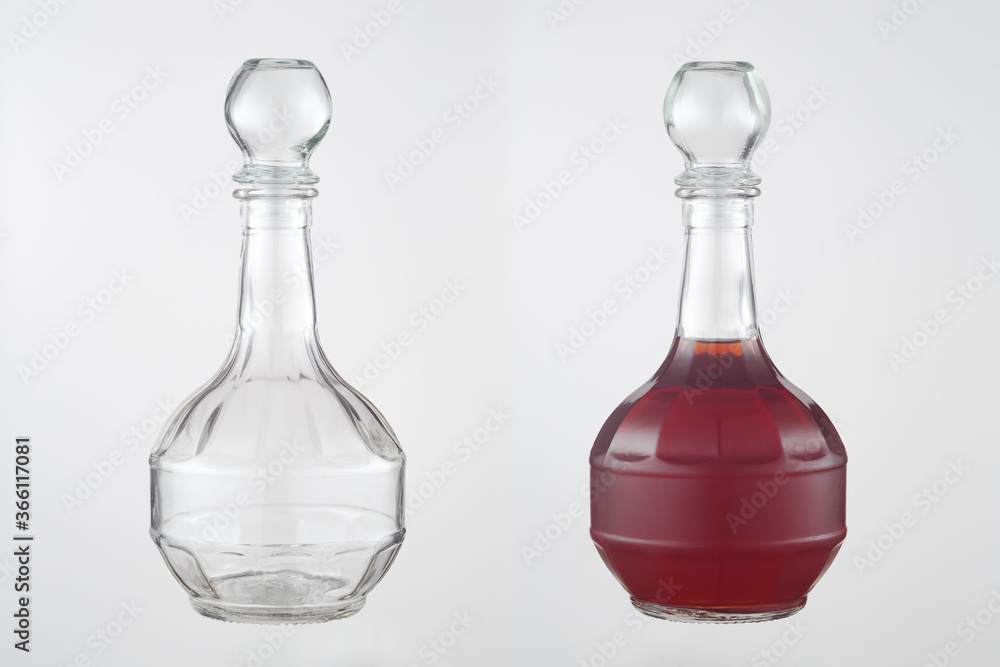 Homemade liqueur in a figured glass decanter with a glass stopper. A set of images on a gray background. Empty and full decanter. Homemade liqueur in a figured glass decanter with a glass stopper. A set of images on a gray background. Empty and full decanter.