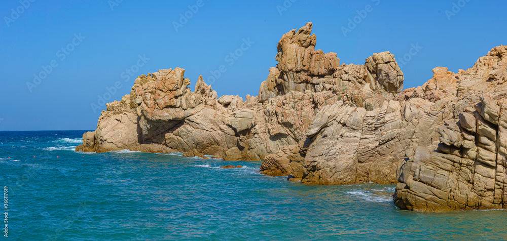 Beautiful shot of rock formations near the sea close to Beach Li Cossi, Sardinia, Italy. Beautiful shot of rock formations near the sea close to Beach Li Cossi, Sardinia, Italy.