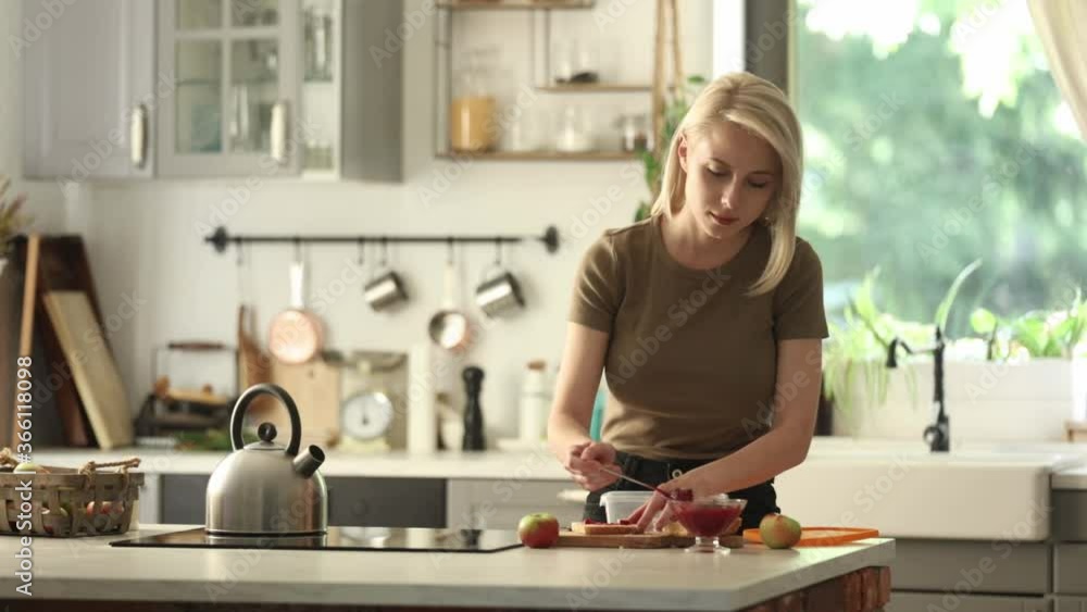 mom prepares lunch box for a child in school on a kitchen at home mom prepares lunch box for a child in school on a kitchen at home