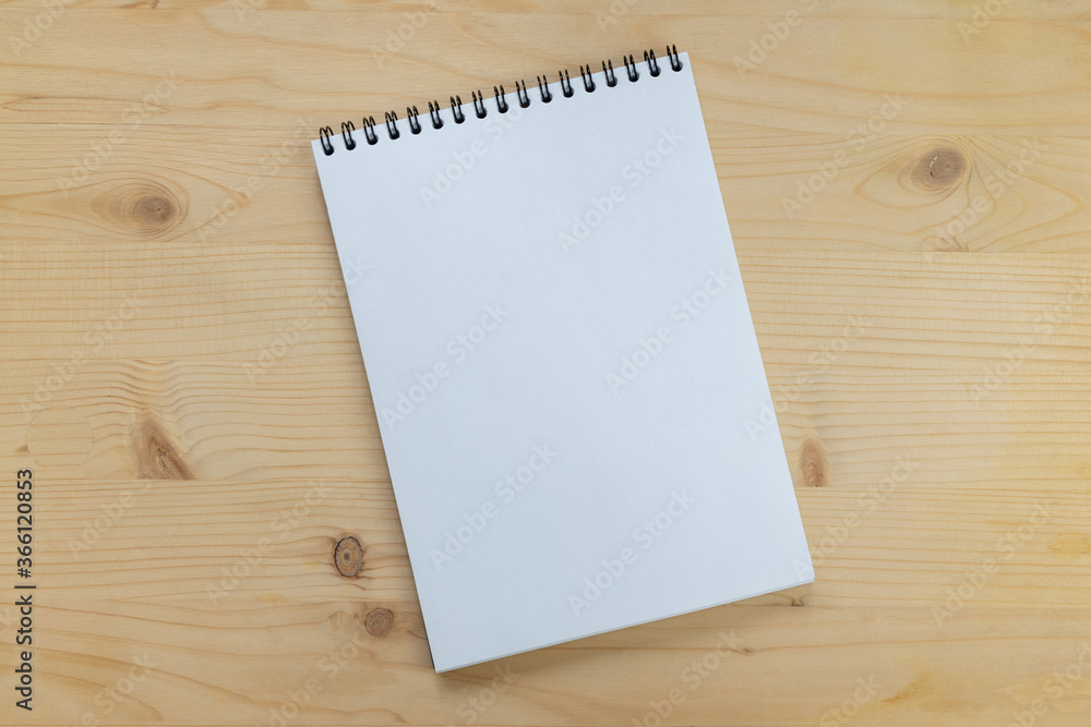 Blank notepad on a wooden background with copy space.