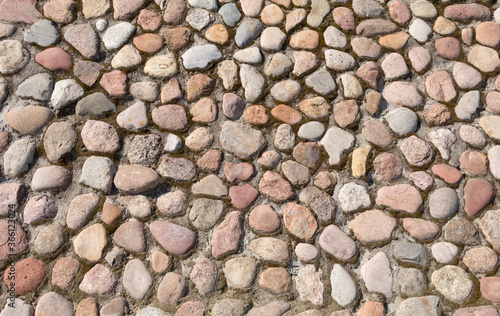 The road is lined with round cobblestones