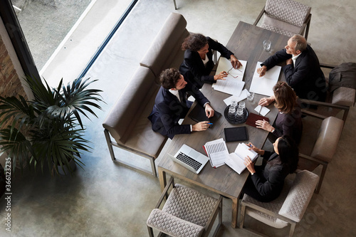 Team of lawyers planning with business colleagues during meeting at law firm