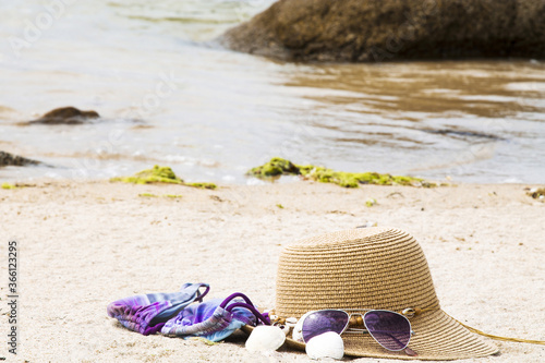 bikini, hat, sunglasses and shells on the beach, summer vacation concept