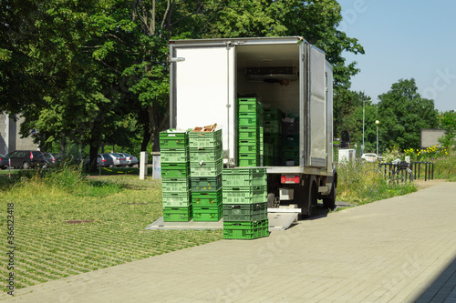 Unloading food crates. Delivery of goods to shops and cafes