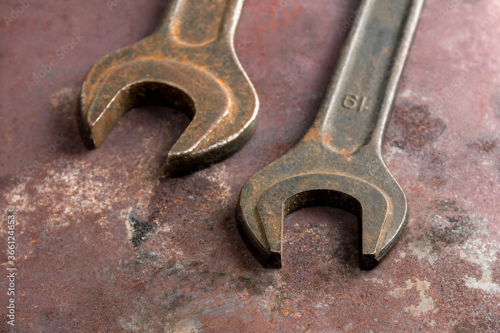 Brutal old wrenches on a metal background