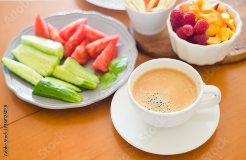 Breakfast with coffee, egg, vegetables and fruits