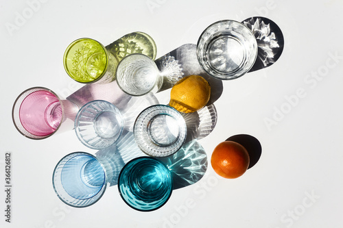 Colored glasses and shadows background. Summer party concept. Minimal pattern.