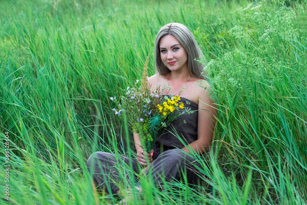 girl with a bouquet of wildflowers in the grass girl with a bouquet of wildflowers in the grass