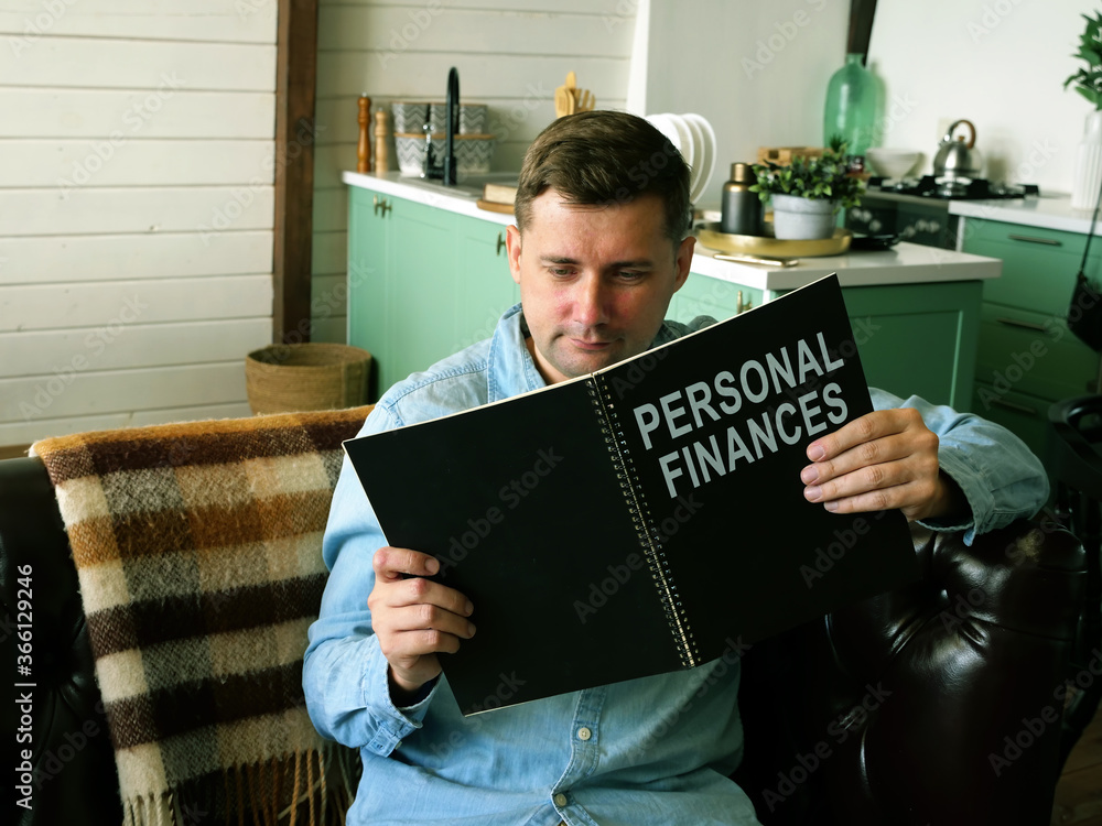 Obraz premium Man reads about personal finances. Financial literacy concept.