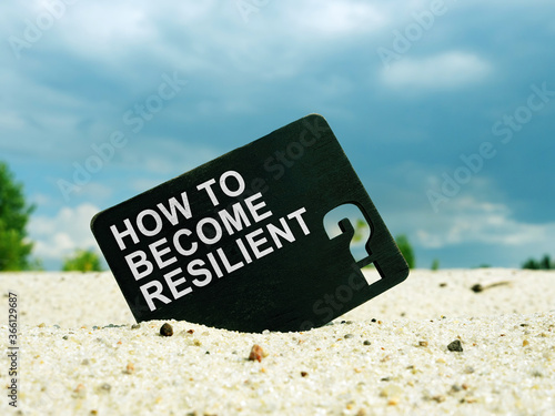 Photography How to Become Resilient words on black plate. Resilience concept.