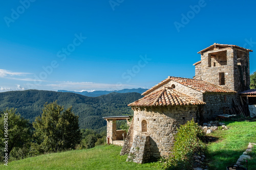 Sant Marti de Toralles Norman church and the Garrotxa Volcanic Zone Natural Park, Pyrenees, Catalonia, Spain photo