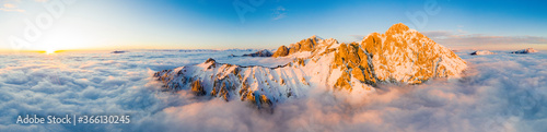 Panoramic aerial view of Grigne group mountain peaks emerging from mist at sunset, Lake Como, Lecco province, Lombardy photo