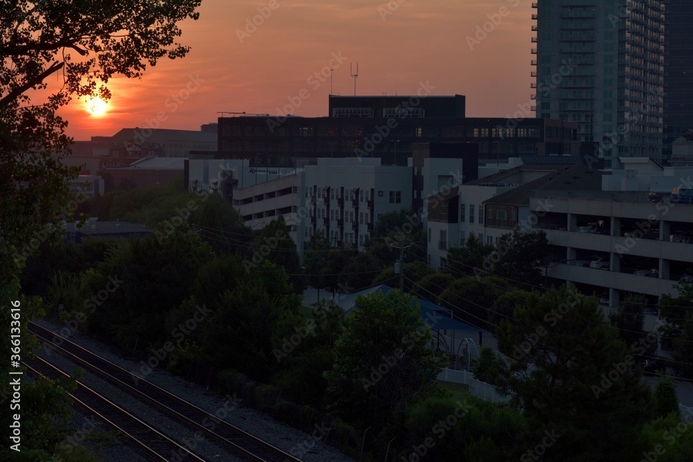 Sunrise over railroad tracks, landscape, and the city Sunrise over railroad tracks, landscape, and the city