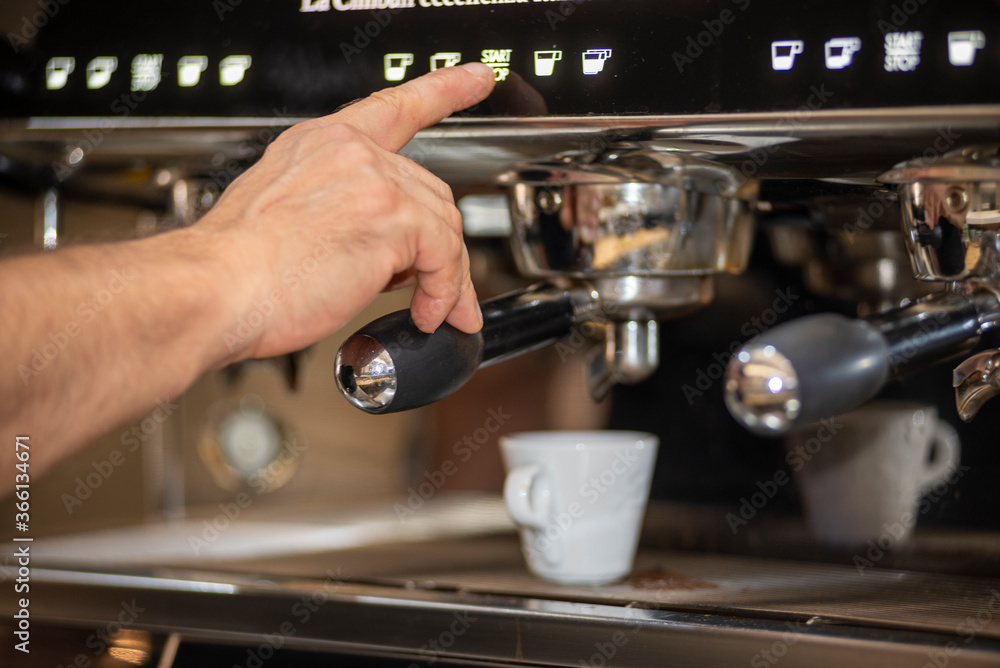 bartender making a coffee while pressing the button